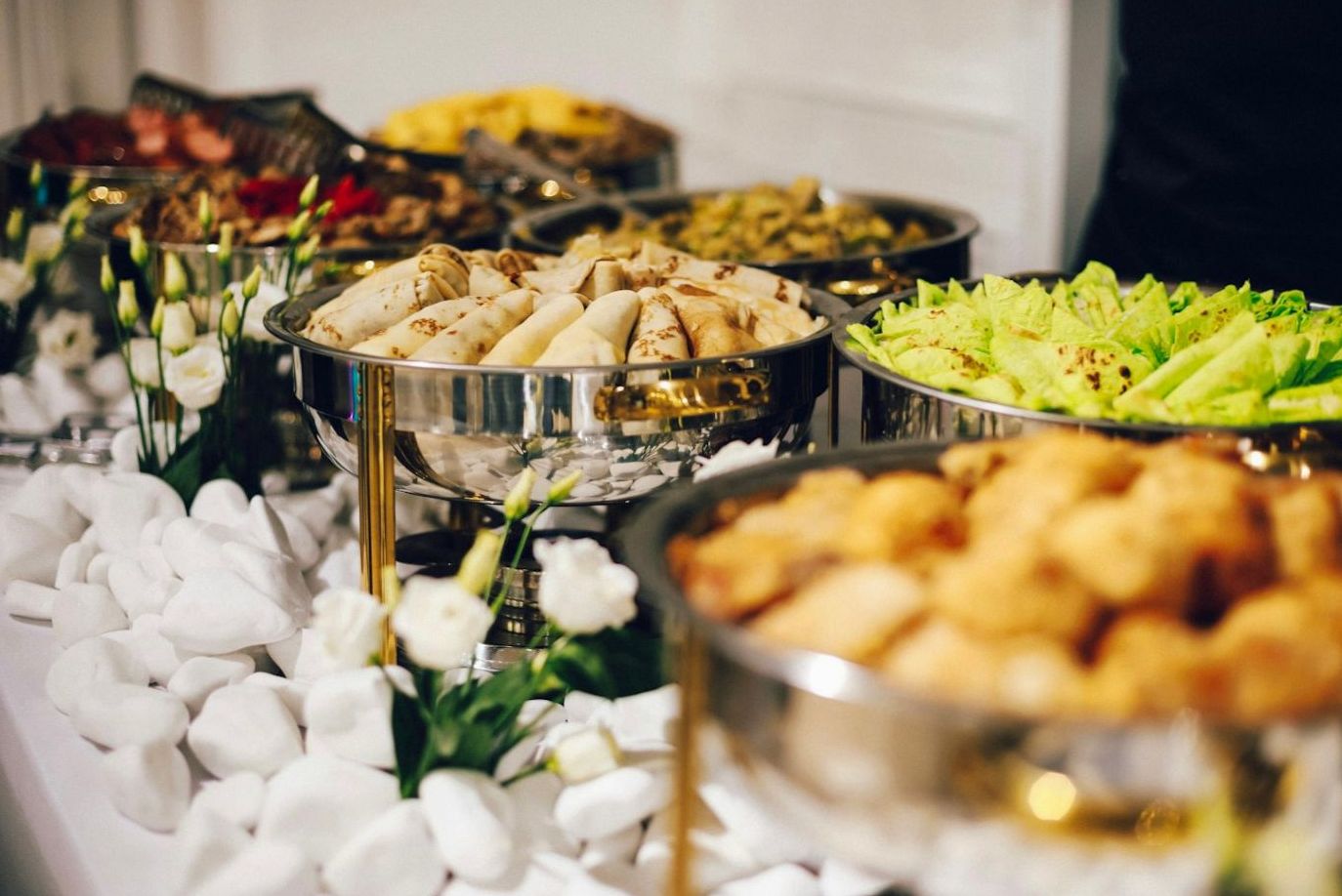Corporate catering spread with fresh shared dishes